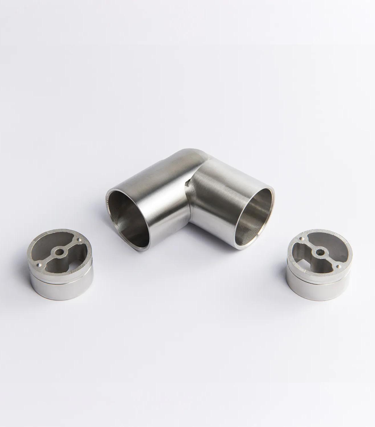 A flexible Stainless Steel metal tube connector positioned between two silver circular mounting inserts 43mm