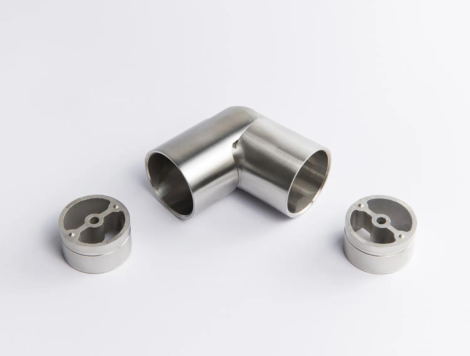 A flexible Stainless Steel metal tube connector positioned between two silver circular mounting inserts 43mm