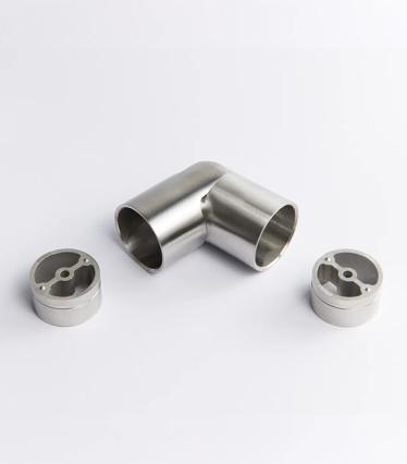 A flexible Stainless Steel metal tube connector positioned between two silver circular mounting inserts 43mm