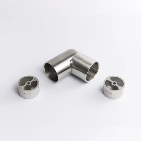 A flexible Stainless Steel metal tube connector positioned between two silver circular mounting inserts 43mm