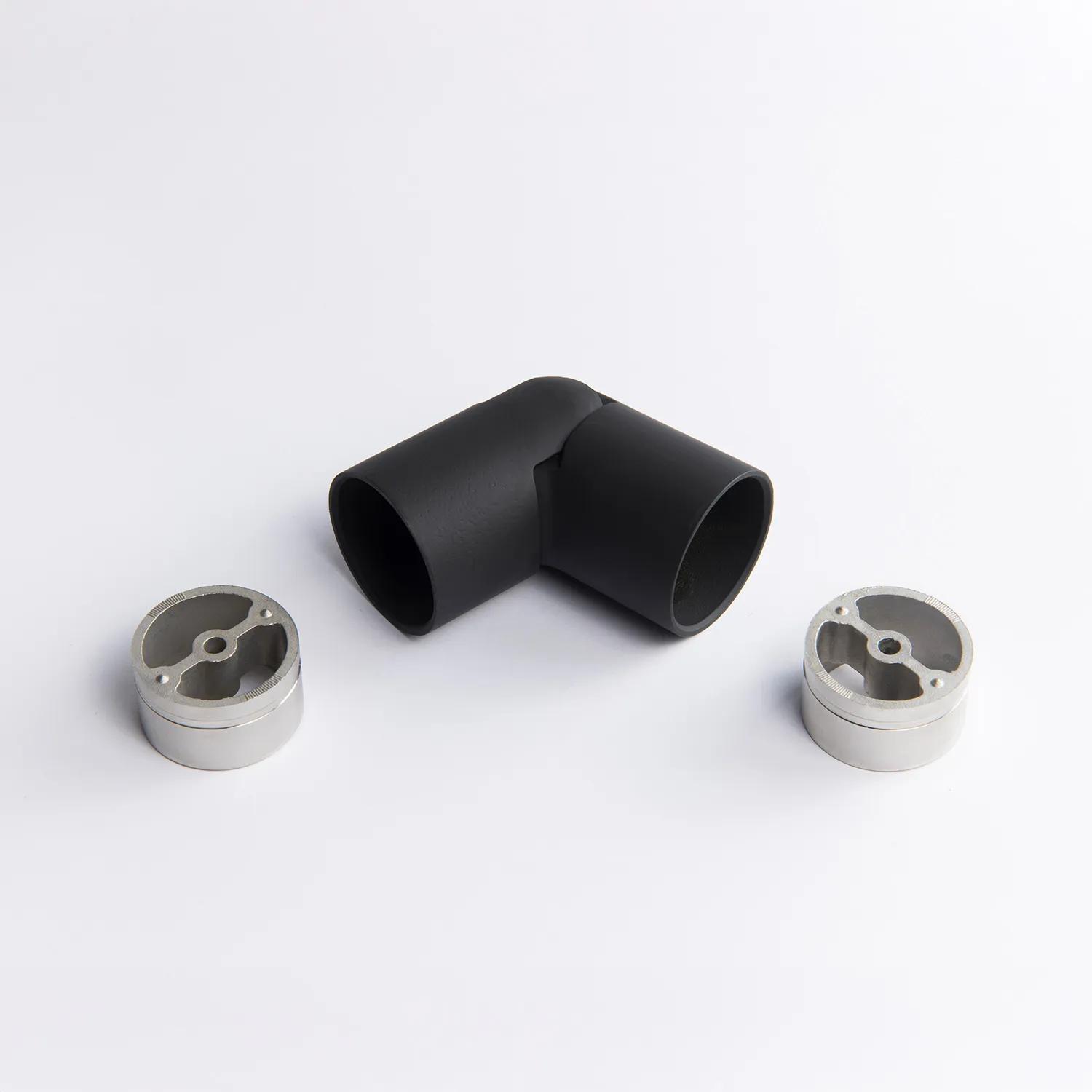 A flexible black metal tube connector positioned between two silver circular mounting inserts 43mm