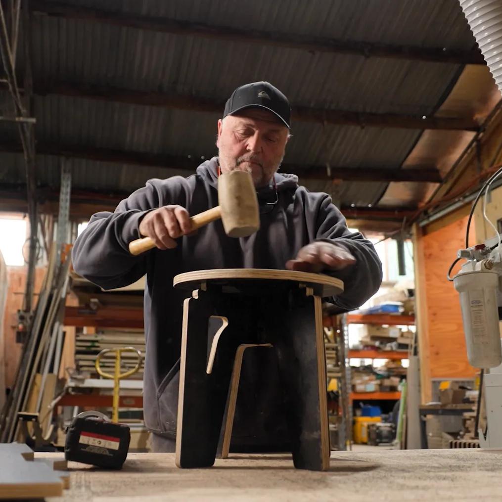 Craftsperson assembling a STRUCTAply project in a woodworking workshop
