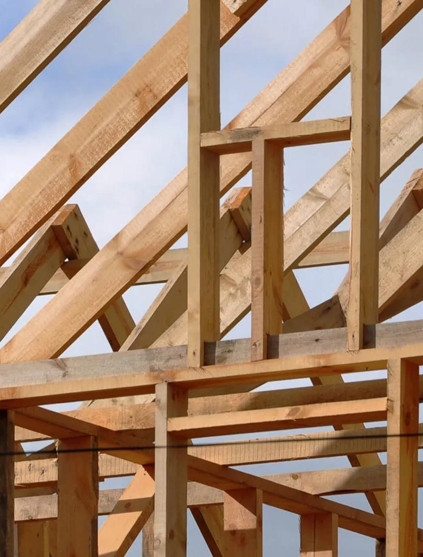 Large wooden beams forming a frame under construction