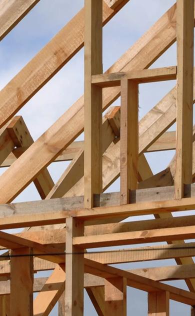 Large wooden beams forming a frame under construction