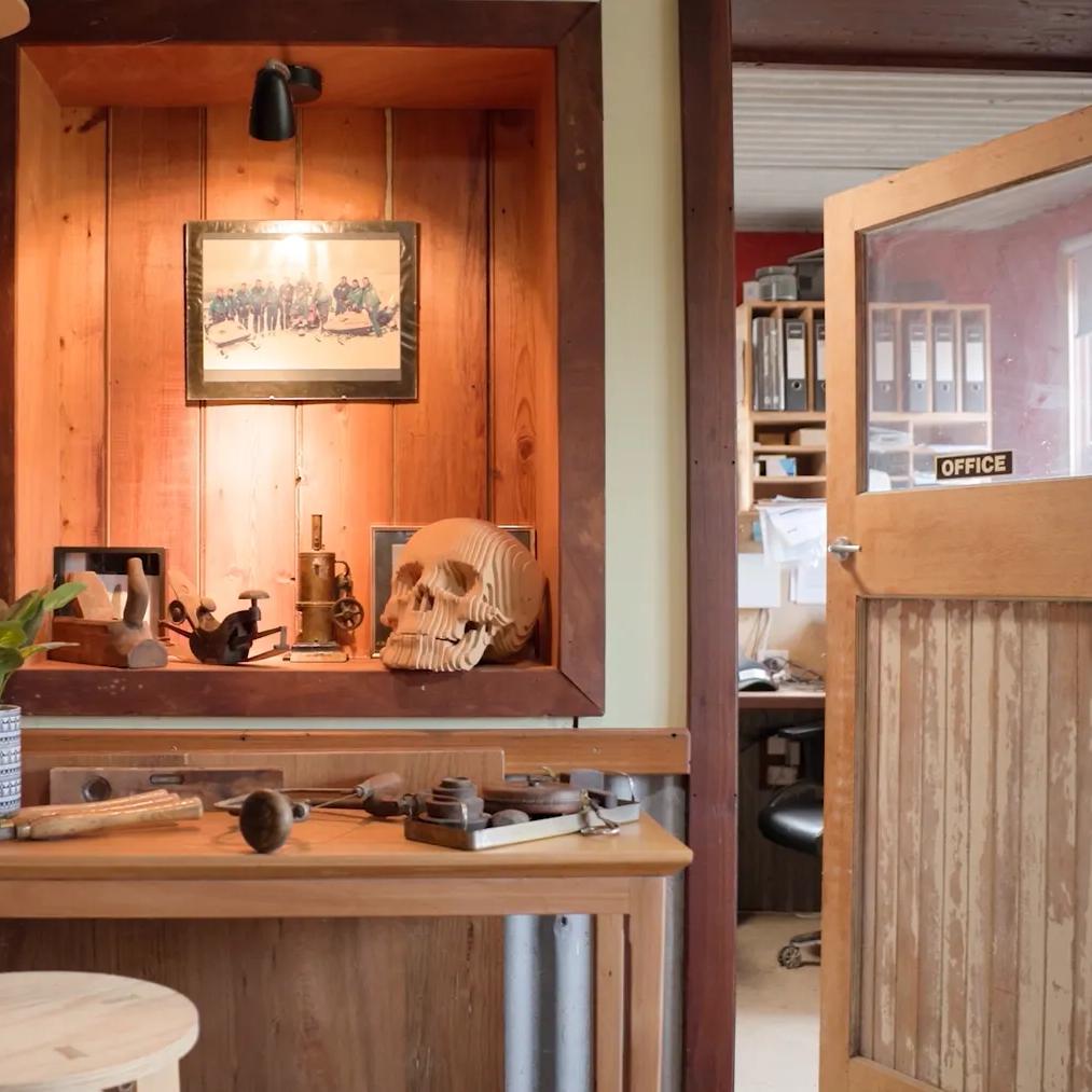 STRUCTAply timber wall panelling in a workshop-style interior with a display niche and workbench