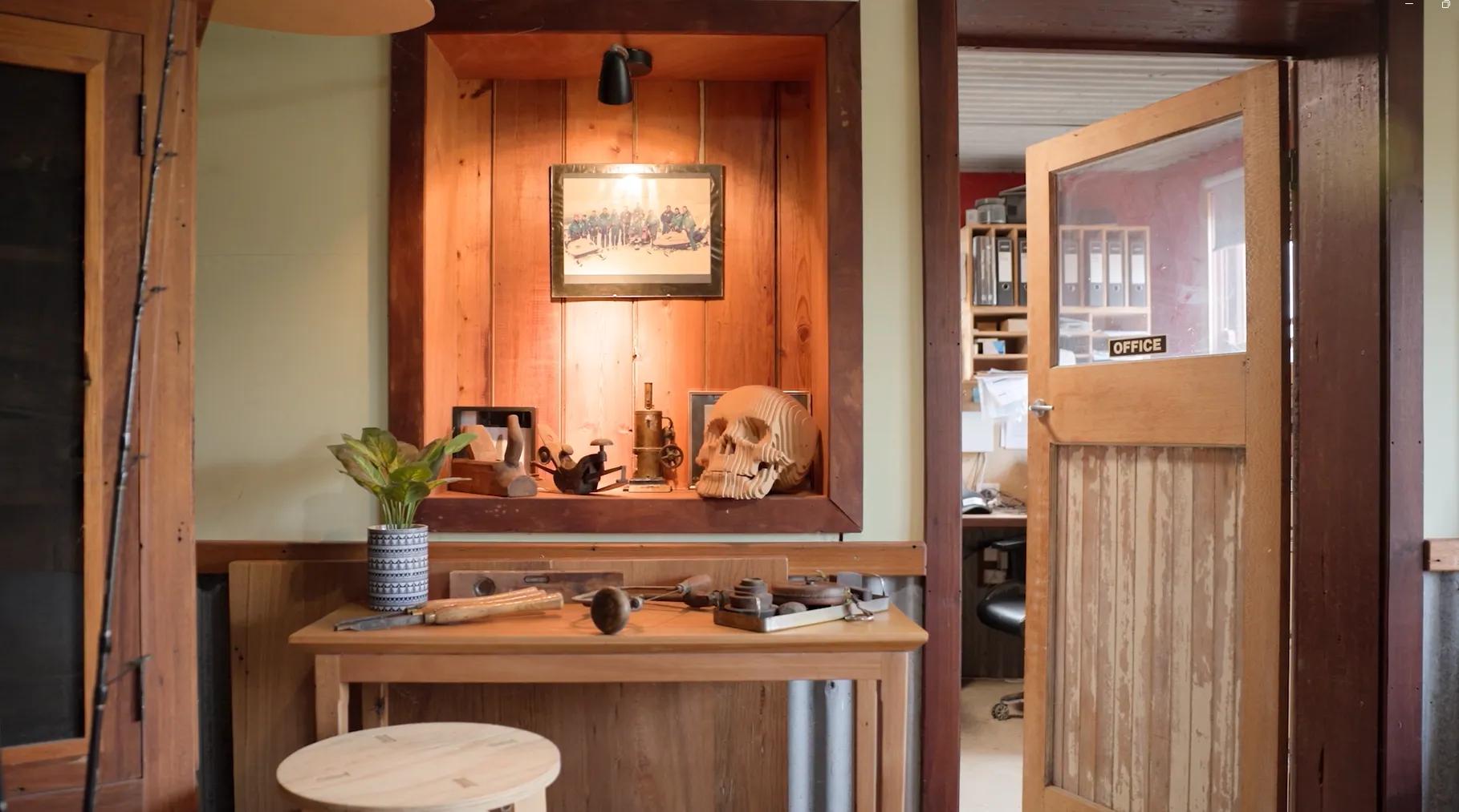 STRUCTAply timber wall panelling in a workshop-style interior with a display niche and workbench