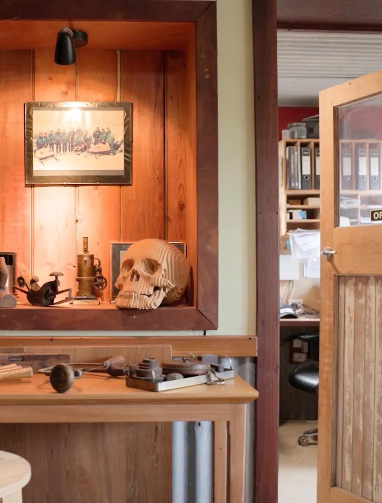 STRUCTAply timber wall panelling in a workshop-style interior with a display niche and workbench