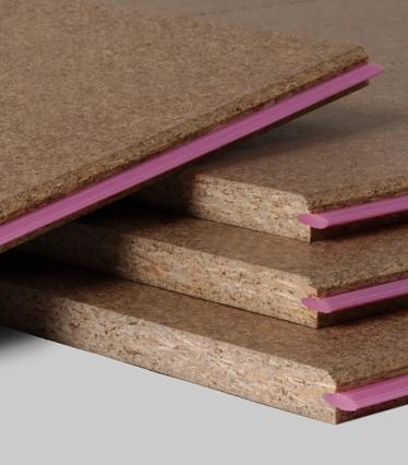 Close up of a stack of STRUCTApanel particleboards, showing the pink tongue edge on the right hand side