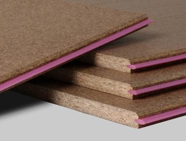 Close up of a stack of STRUCTApanel particleboards, showing the pink tongue edge on the right hand side