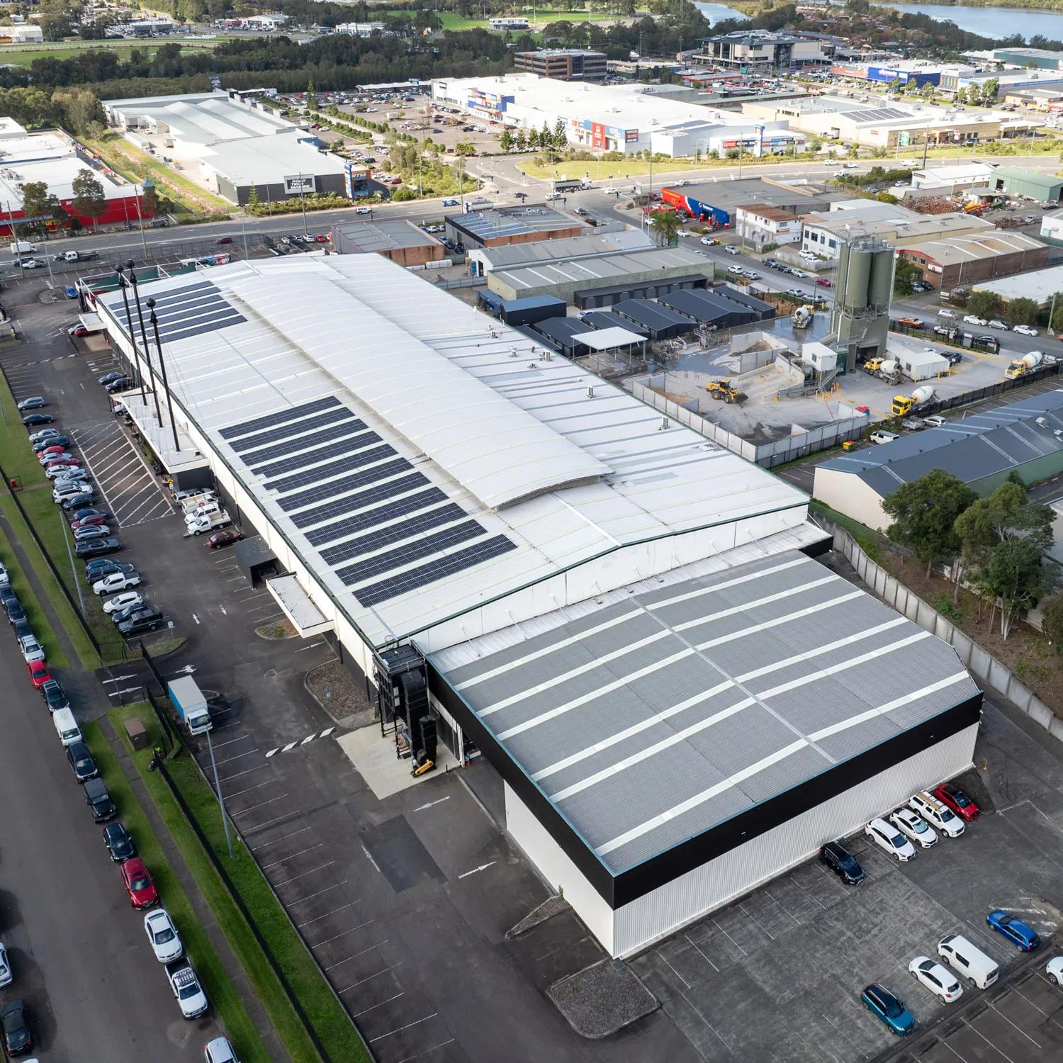 This is an aerial view of a warehouse with solar panels on the roof