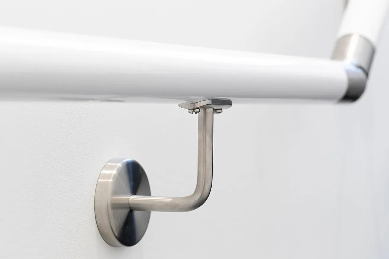 Metal handle on white railing