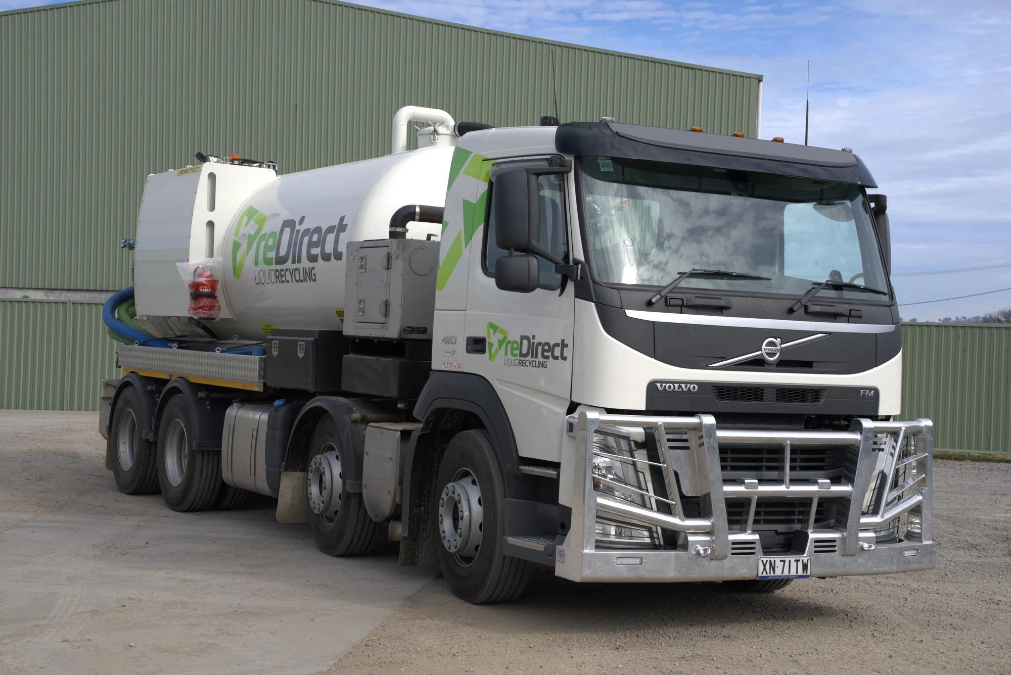 reDirect Liquid Recycling Volvo tanker truck front-angle view in open yard.