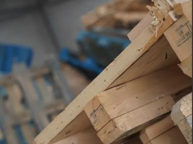 Close-up of stacked timber pallets in warehouse ready for recycling.