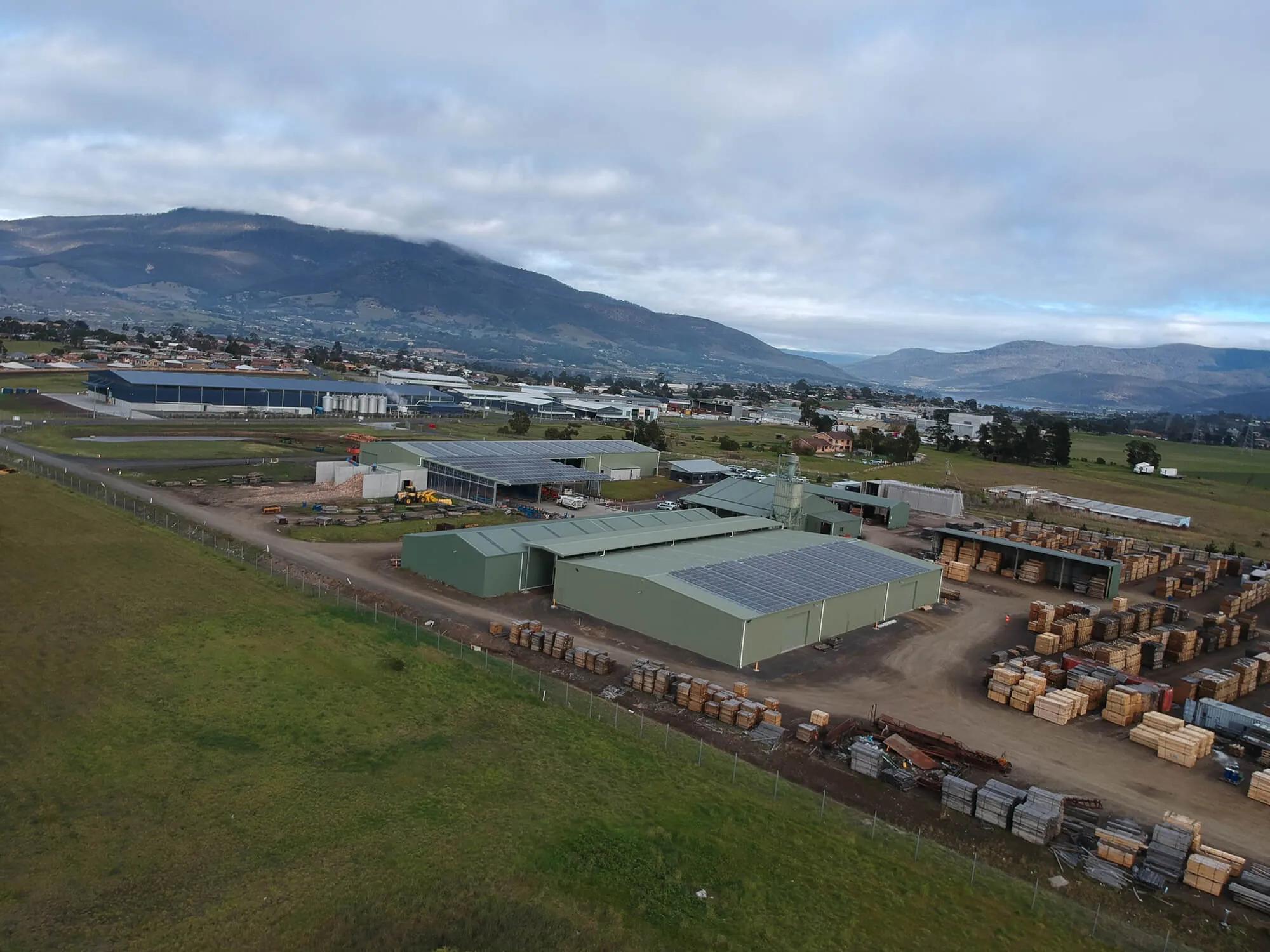 A large industrial area, likely a wood processing facility, with numerous structures and machinery
