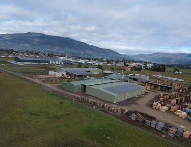 A large industrial area, likely a wood processing facility, with numerous structures and machinery
