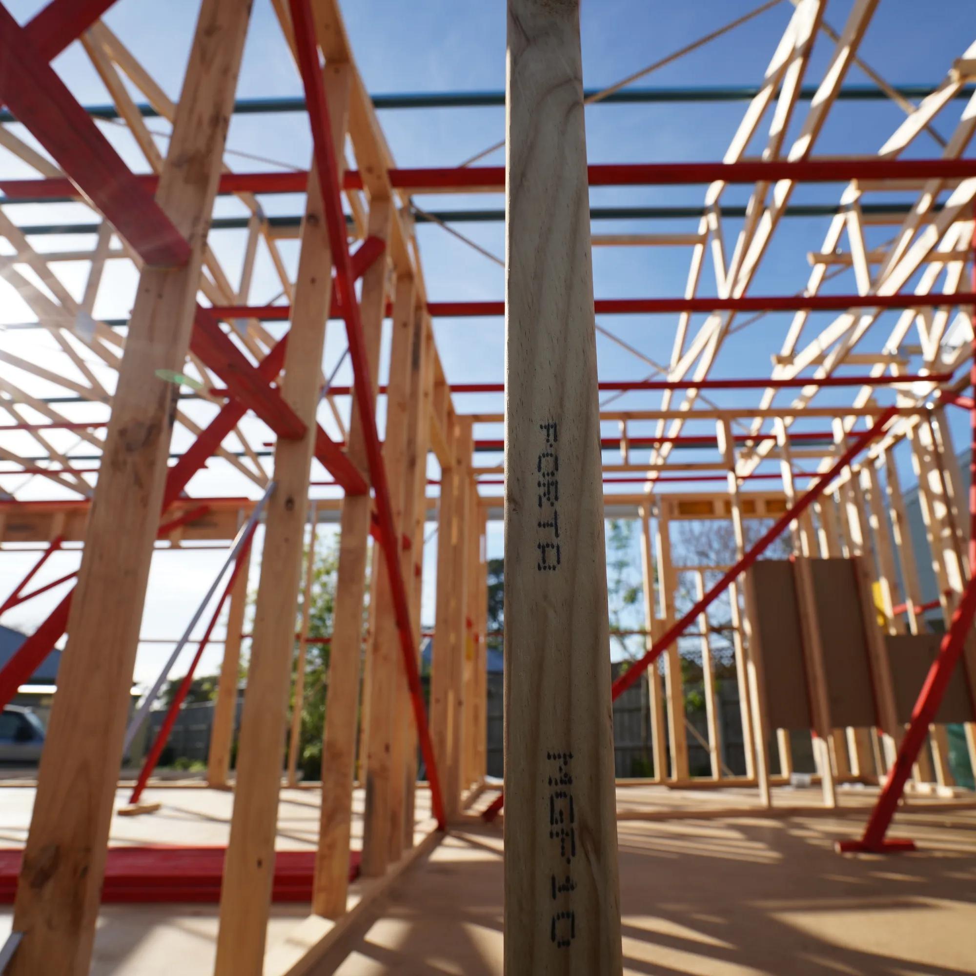 Porta timber framing and red bracing inside a house under construction