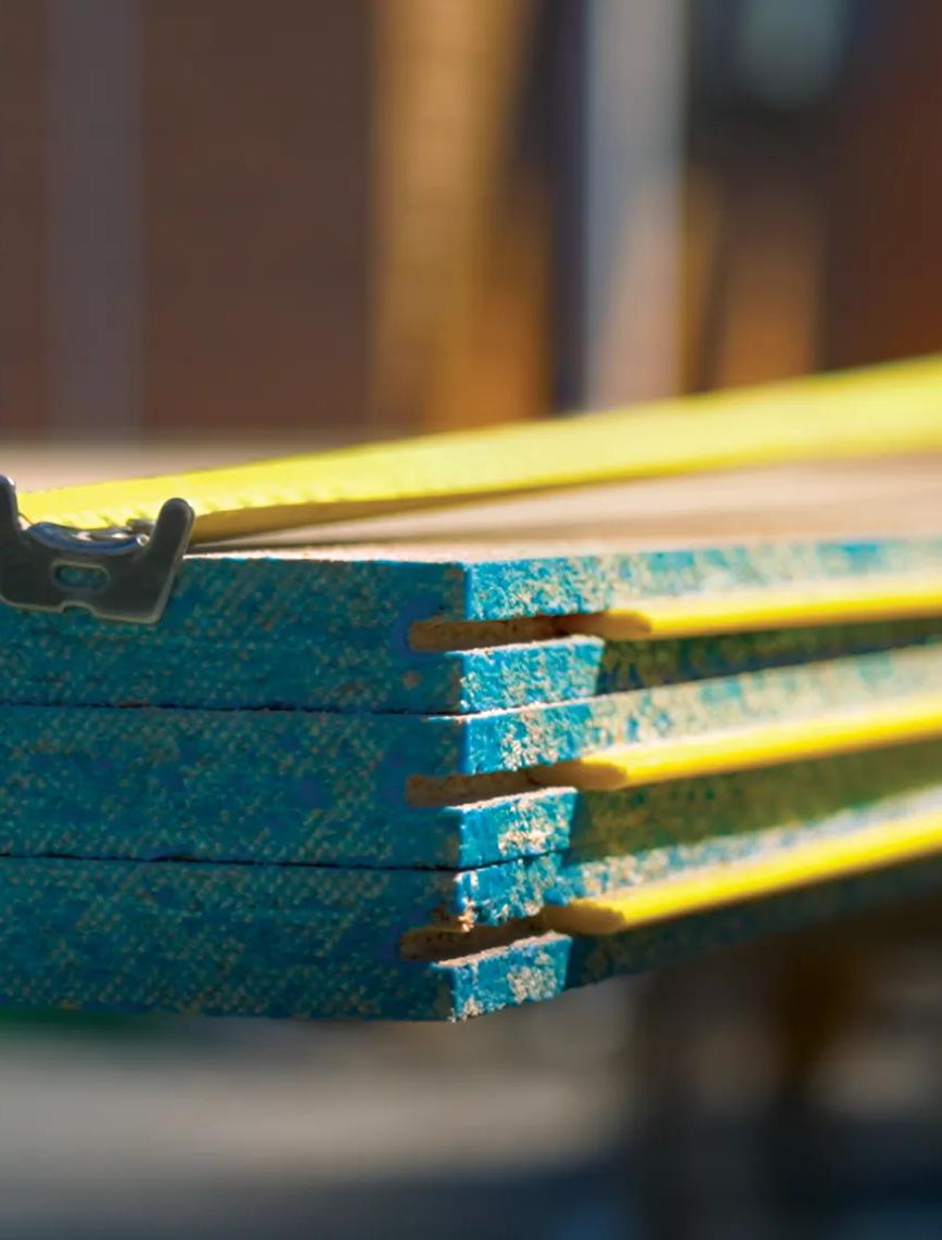 Stack of STRUCTAflor Termite treated with a tape measure