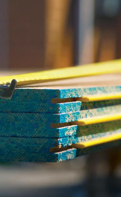 Stack of STRUCTAflor Termite treated with a tape measure