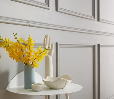 A table with a vase of yellow flowers on it