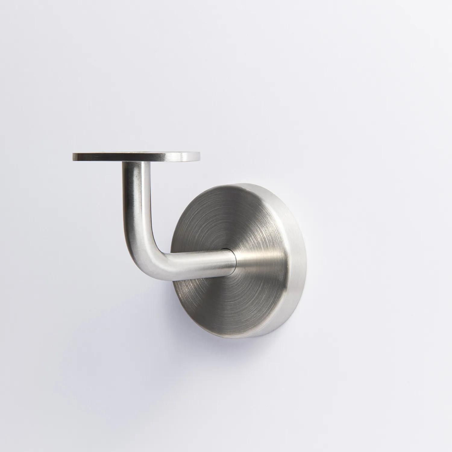 A handrail bracket with a round base plate, a curved support arm, and a flat mounting plate on top in Stainless Steel 70mm 43mm