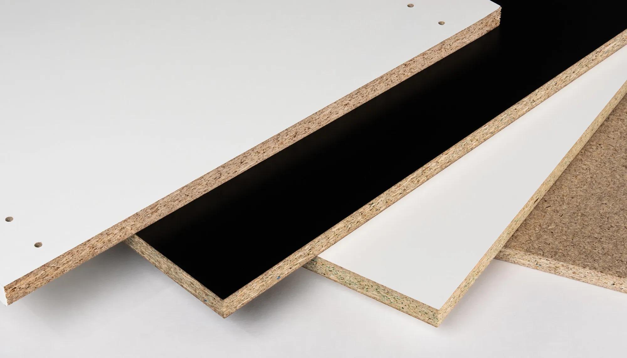 Three sheets of particleboard with visible edges