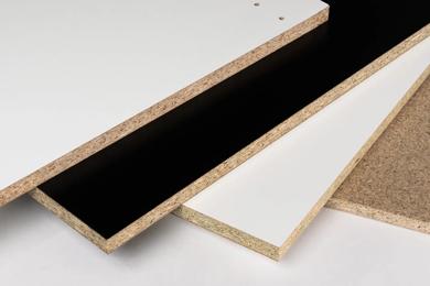 Three sheets of particleboard with visible edges