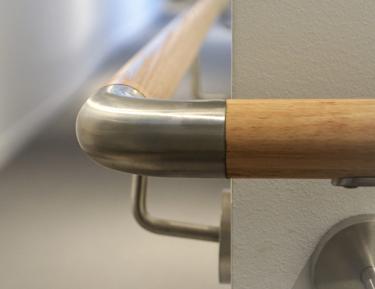 Metal adjustable bend on white railing