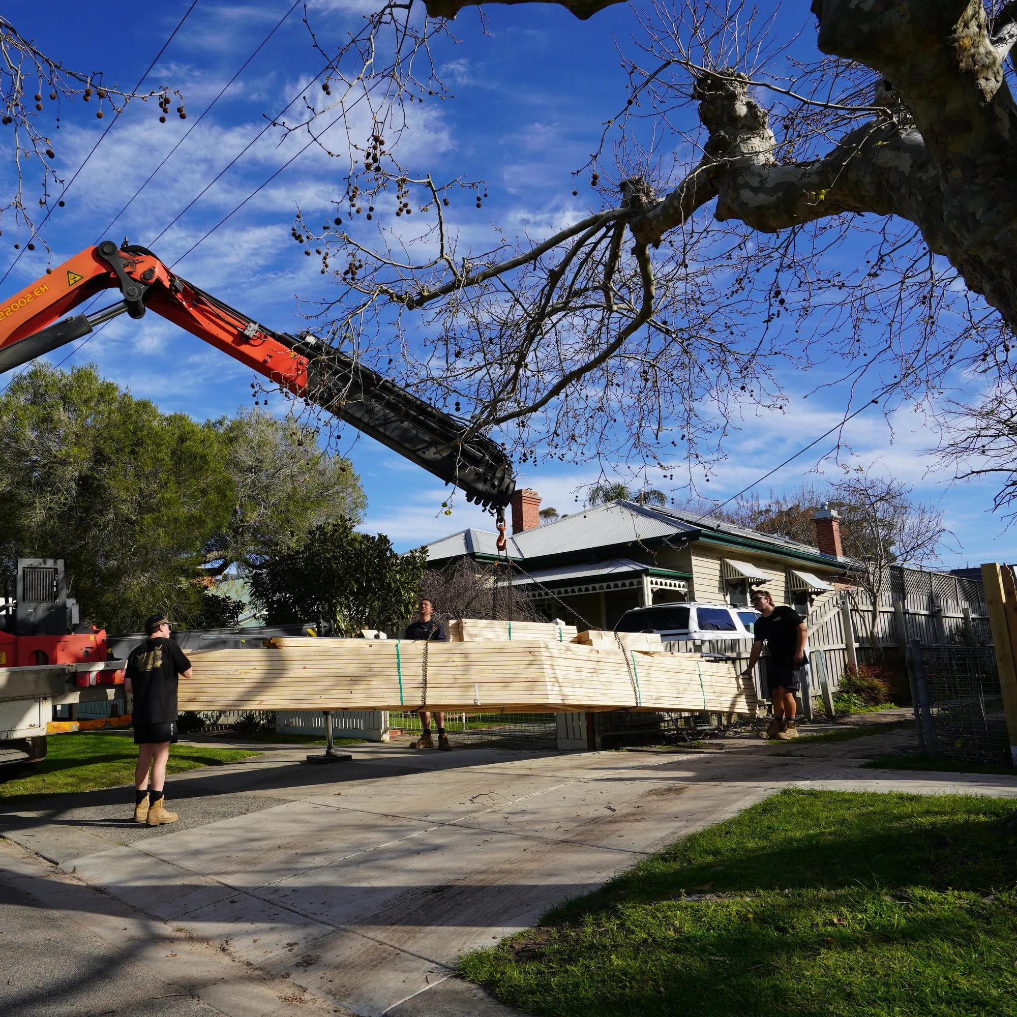 Porta timber panels being delivered by crane truck to a residential property
