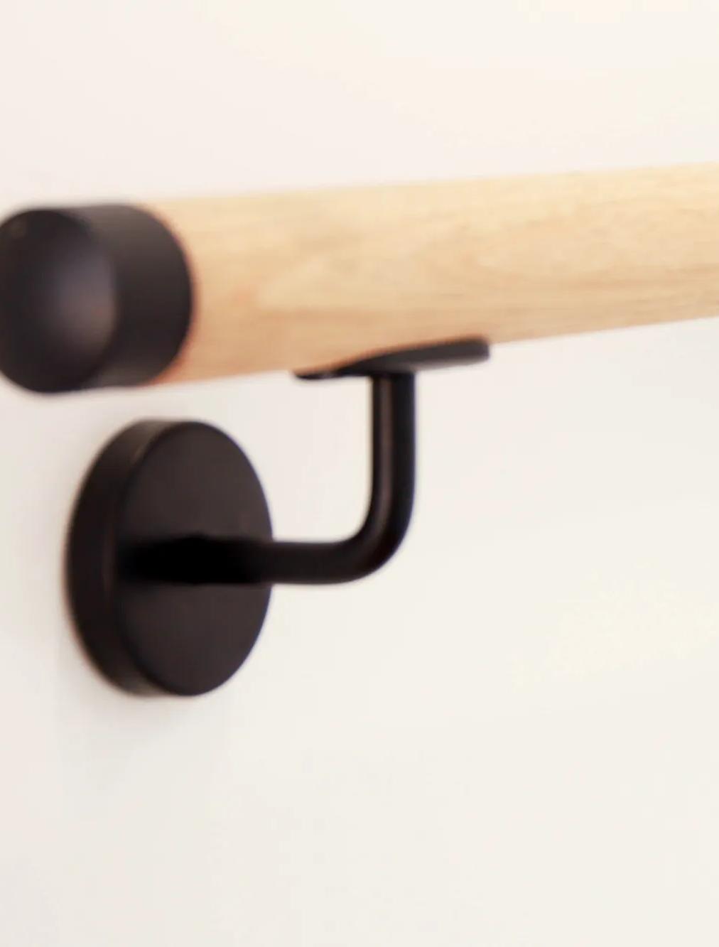 Wooden curved towel rack on wall