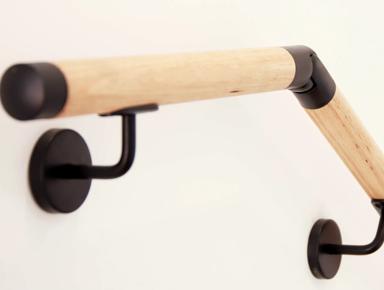 Wooden curved towel rack on wall