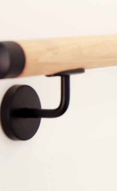 Wooden curved towel rack on wall
