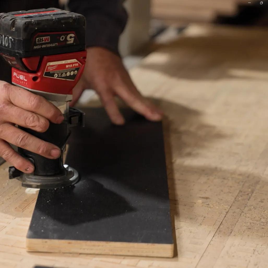 Person using a power sander on a STRUCTAply panel in a workshop
