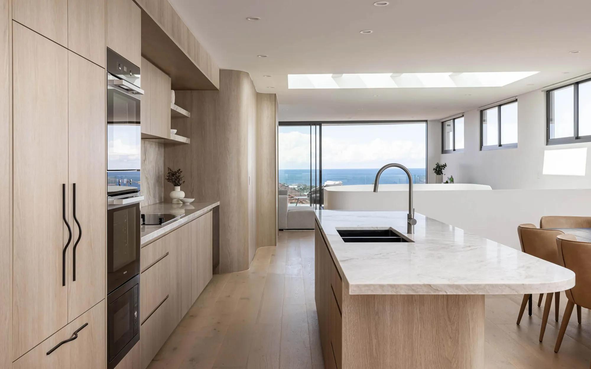 Modern kitchen with white cabinets and marble countertops