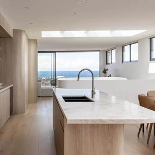 Modern kitchen with white cabinets and marble countertops