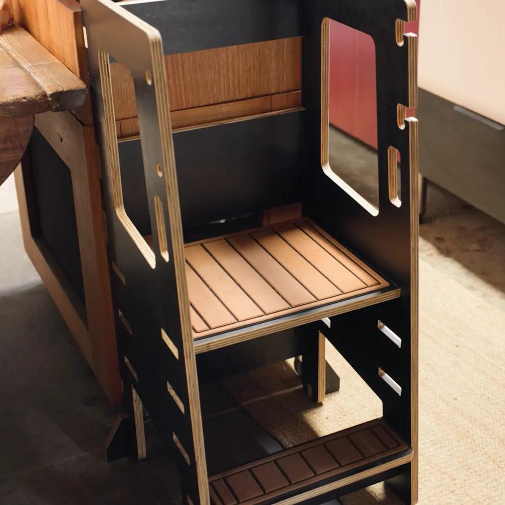 STRUCTAply plywood shelving unit beside a workbench in an interior setting