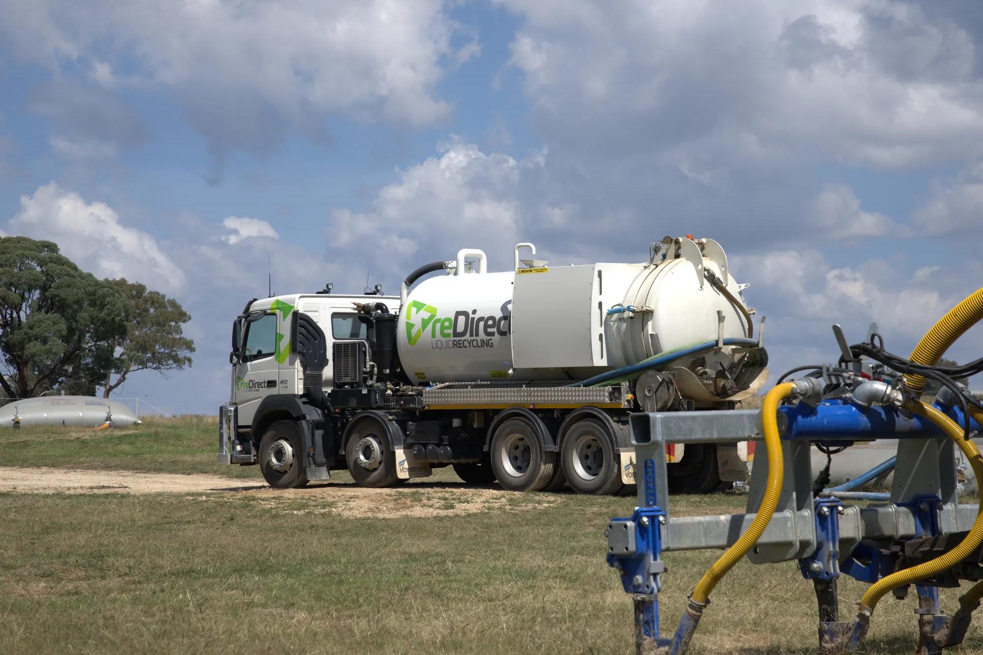 reDirect Liquid Recycling tanker truck operating in rural paddock.