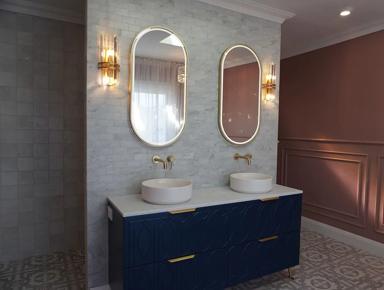 A wall-mounted mirror in a bathroom