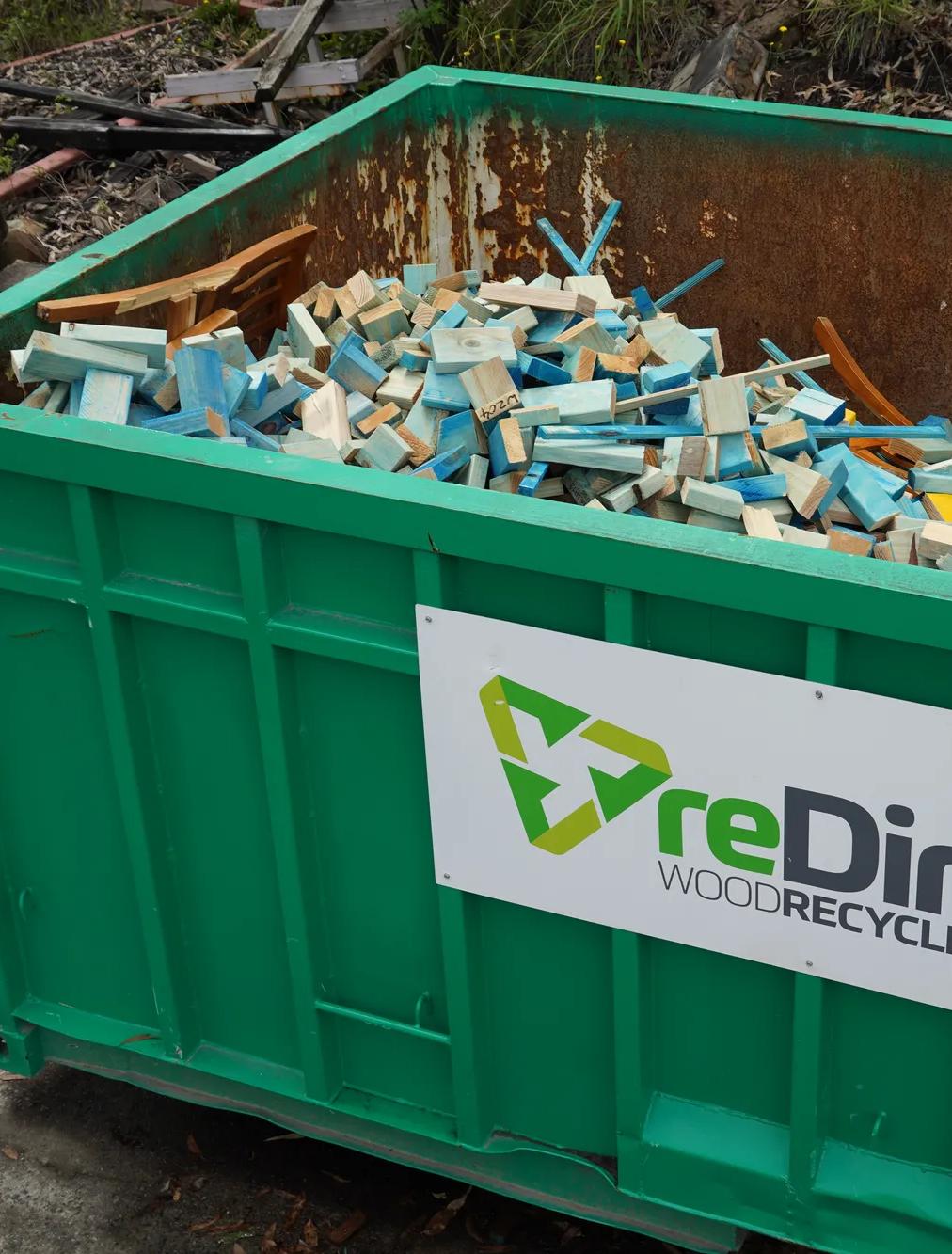 reDirect Wood Recycling bin filled with blue-painted frame and truss timber.