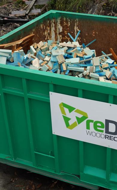reDirect Wood Recycling bin filled with blue-painted frame and truss timber.