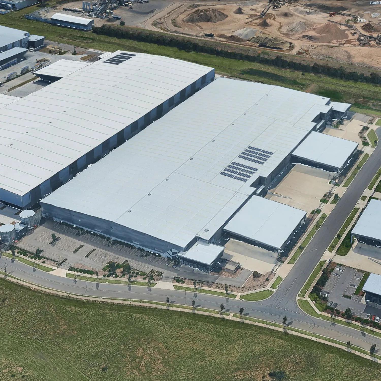 White warehouse building in a rural area