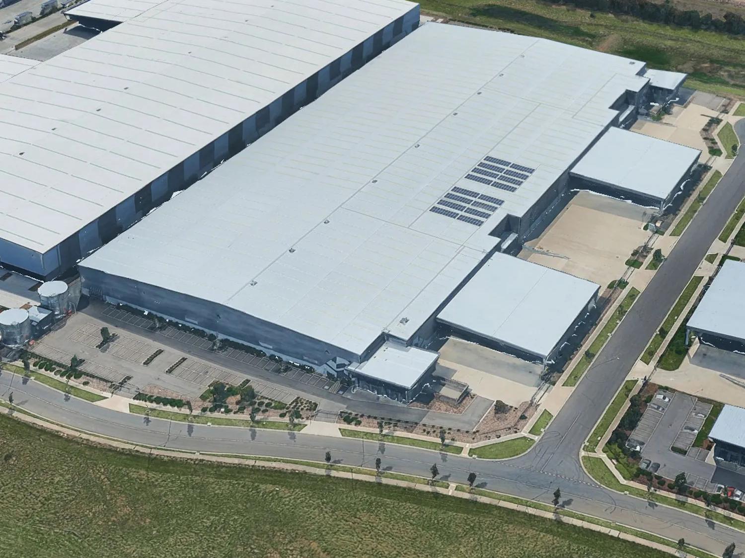 White warehouse building in a rural area