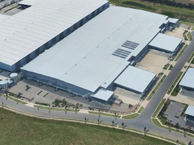 White warehouse building in a rural area