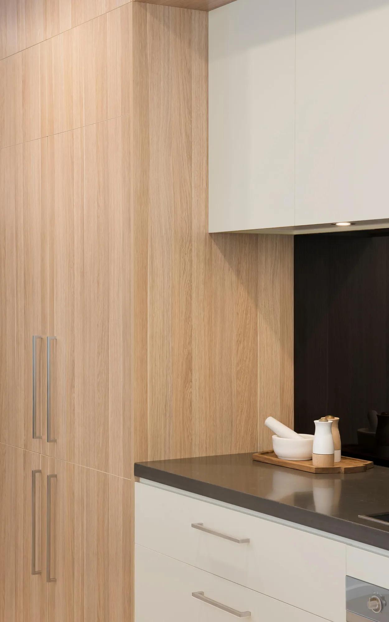 Modern kitchen with wooden cabinets and black countertop