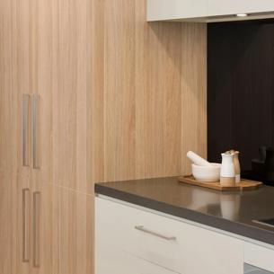 Modern kitchen with wooden cabinets and black countertop
