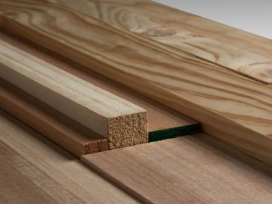 A collection of wooden planks stacked horizontally. These planks have visible wood grain patterns, and their ends show a smooth finish. The image focuses on the construction material aspect of the scene, emphasizing the quality of the wood, with close-up details showcasing the texture and color variations in the wood fibers