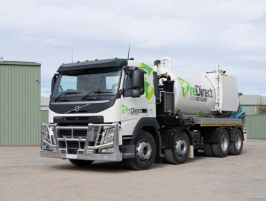 reDirect Liquid Recycling Volvo tanker truck side view outside green shed.