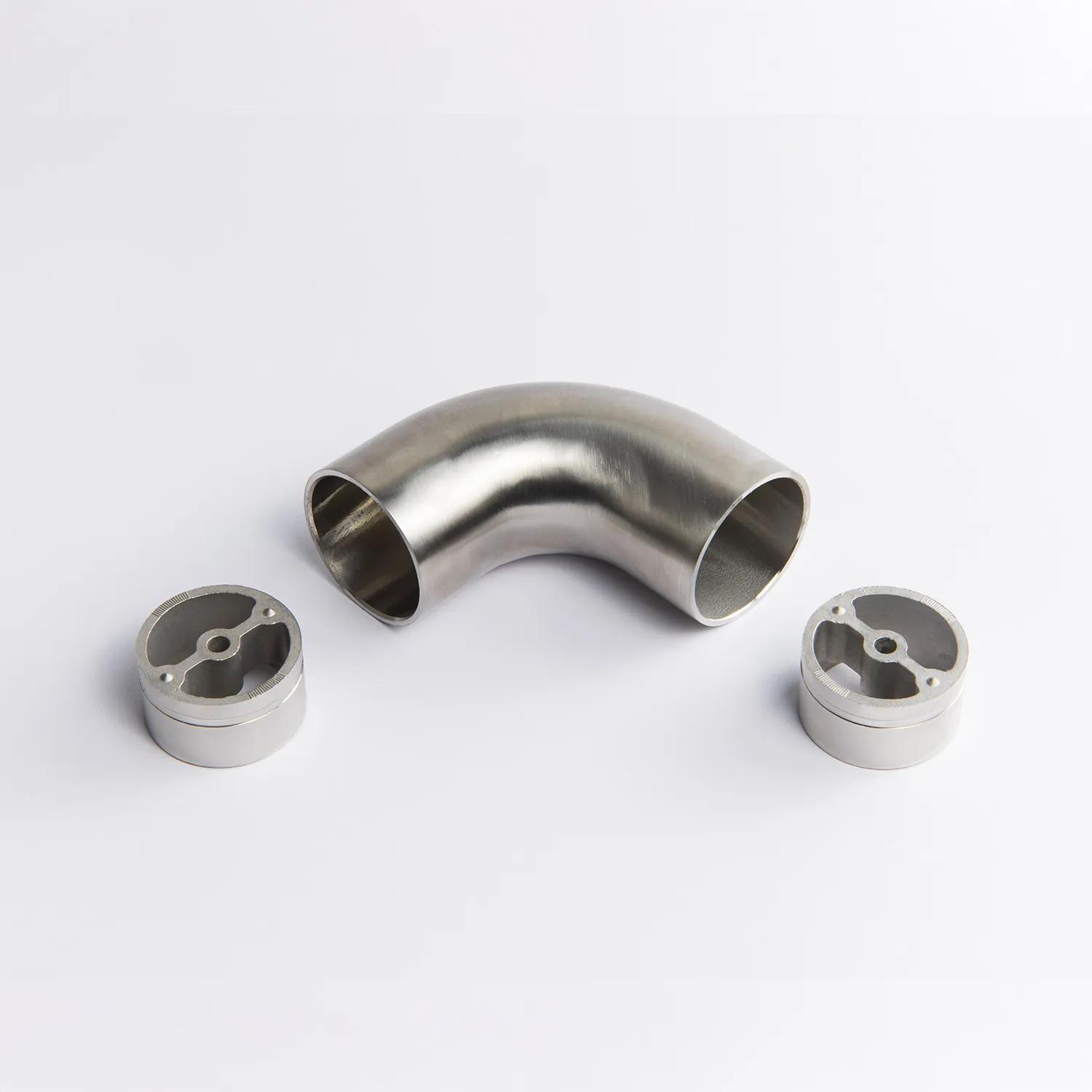 A fixed 90 Degree Stainless Steel metal tube connector positioned between two silver circular mounting inserts 65mm x 43mm