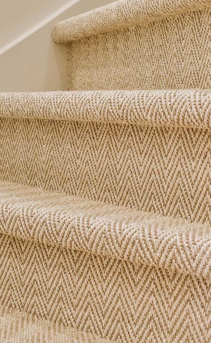 Staircase of beige steps with dark brown carpet