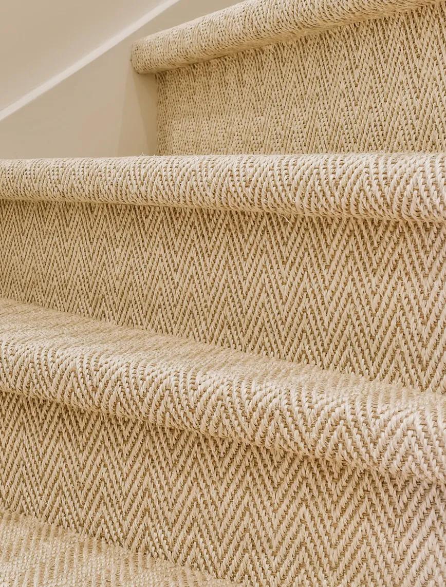Staircase of beige steps with dark brown carpet